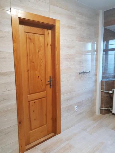 a wooden door in a room with a wall at Chalupa U Potoka in Staré Hory