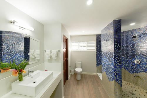 a bathroom with a sink and a shower and a toilet at Coral Cay Villas in Cherryfield