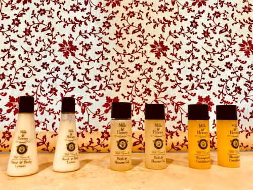 four bottles of lotion on a counter in front of a wall at The Dorset Arms Pub & Cottage Rooms in Groombridge