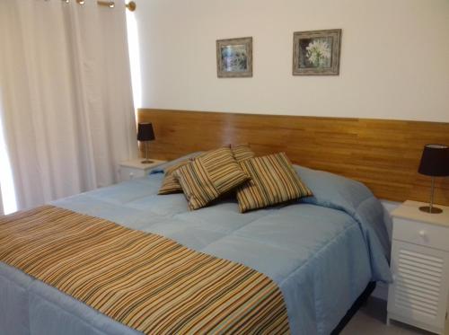 a bedroom with a bed with two pillows on it at Bellagio Tower in Punta del Este
