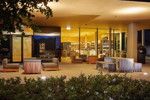 a library with couches and tables in a building at LOISIUM Wine & Spa Hotel Südsteiermark in Ehrenhausen