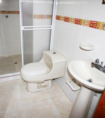 a bathroom with a toilet and a sink at El Velero Apartamentos By DANP in Santa Marta