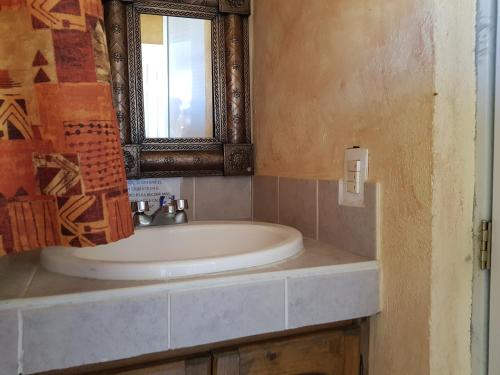 a bathroom with a sink and a mirror at Hotel Colonial San Jorge in Monclova