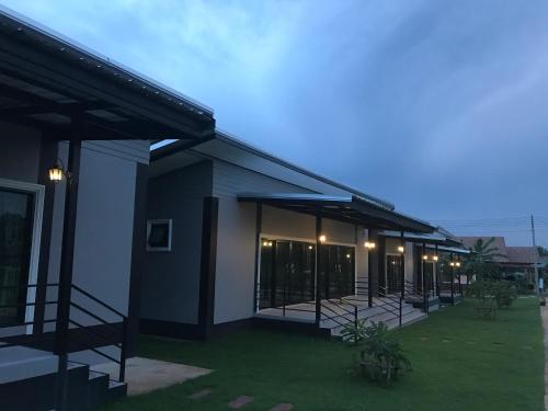 a building with a lot of windows and lights at Lek Village Khaoyai in Pak Chong