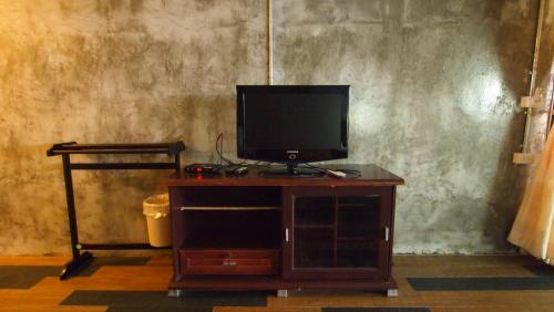 a tv sitting on top of a wooden stand at Crescent Bay Resort in Ko Samed