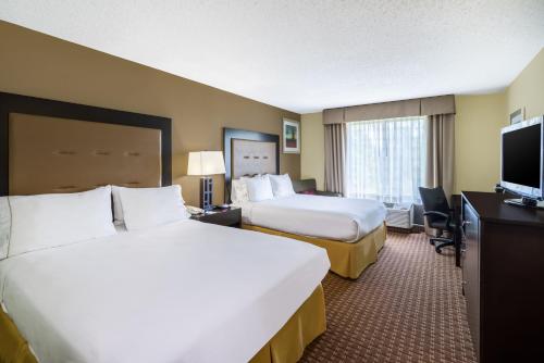 a hotel room with two beds and a flat screen tv at Holiday Inn Express Hotel & Suites-North East by IHG in North East