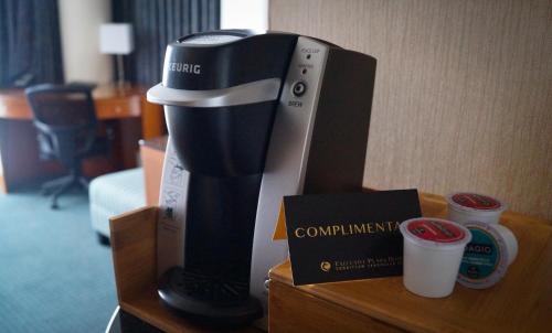 a coffee maker on a table in a hotel room at Executive Plaza Hotel & Conference Centre, Metro Vancouver in Coquitlam