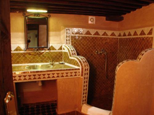 a bathroom with a sink and a mirror at Riad Sheryne Fes in Fez