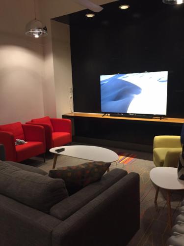 a living room with a couch and a projection screen at Granville Hall Residence in Halifax