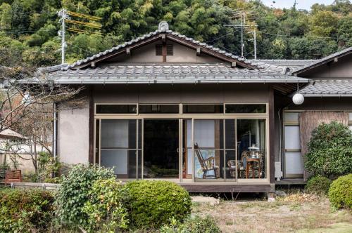 a house with a large window on the front of it at 88 House Hiroshima in Hiroshima