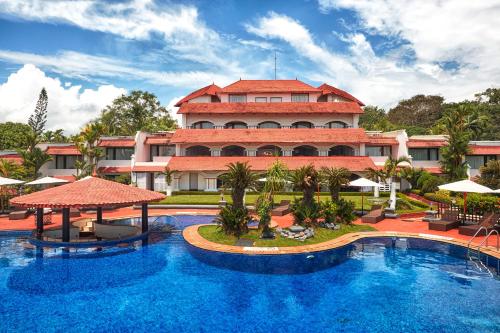 a resort with a large swimming pool in front of a building at Gateway Varkala - IHCL SeleQtions in Varkala