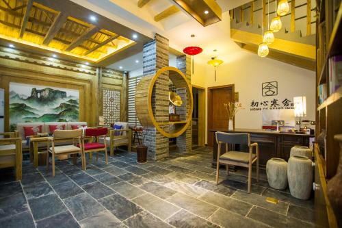 a restaurant with a table and chairs in a room at Home of heart Inn in Zhangjiajie