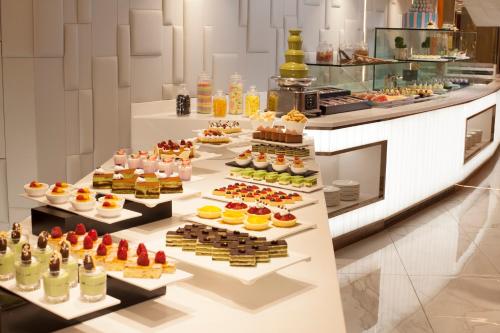 a buffet line with many different types of desserts at Park Hotel Hong Kong in Hong Kong