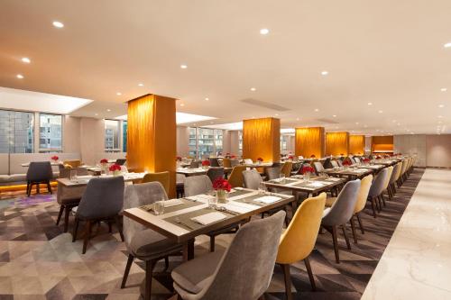 a dining room with long tables and chairs at Park Hotel Hong Kong in Hong Kong