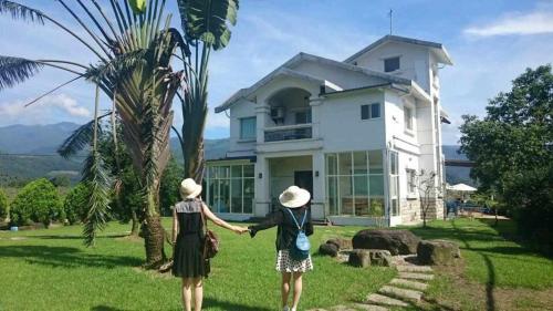 two women standing in front of a house at Star House in Tianfu