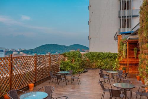 a patio with tables and chairs on a balcony at Metropolo Jinjiang Xuzhou Railway Station Suning Plaza Chudu in Xuzhou