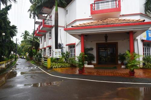 a rain soaked street in front of a building at BEAUTIFUL SPACIOUS STUDIO APT IN CANDOLIM with Wifi in Candolim