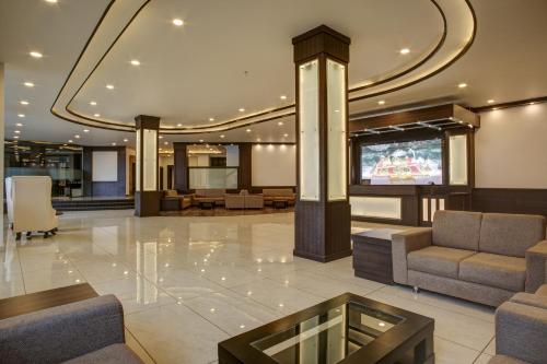 a lobby with couches and a tv in a building at Hotel The Royal Krishna in Katra
