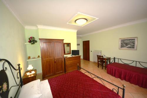 a bedroom with a bed and a desk and a table at Bigotti in Fano