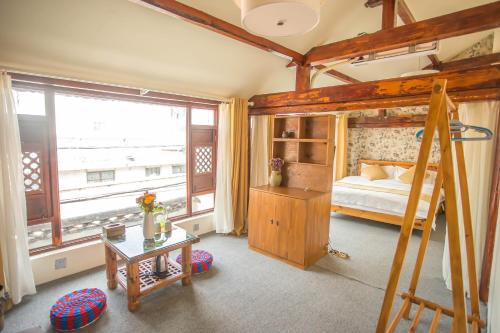a bedroom with a bunk bed and a ladder at Log Cabin in Dali