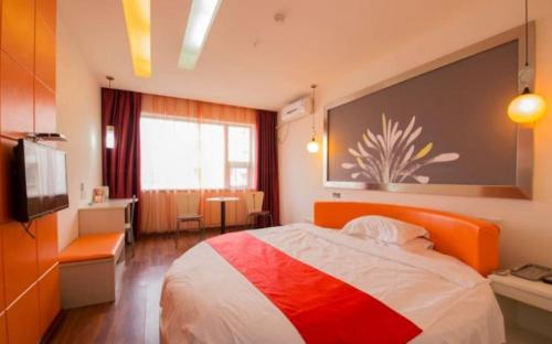 a bedroom with a bed and a television in it at Thank Inn Chain Hotel Sichuan Nanchong in Nanchong