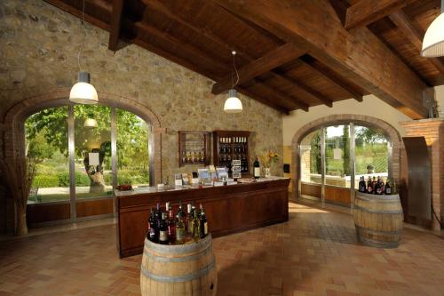 a wine tasting room with barrels of wine bottles at Agriturismo Le Gallozzole in Monteriggioni