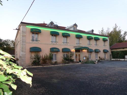 a building with green lights on the side of it at Cit'Hotel du Tigre in Verdun