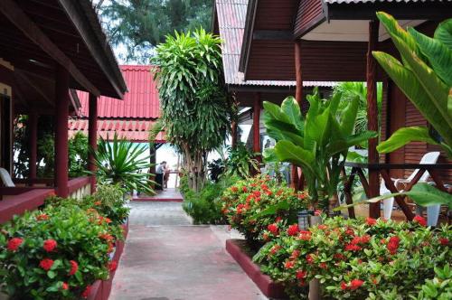 a garden with flowers and plants in front of a building at Island View Bungalows in Choeng Mon Beach