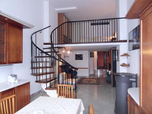 a hallway with a spiral staircase in a house at Appartamenti Lago di Como in Valbrona