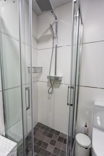 a bathroom with a glass shower with a toilet at Cañete Medica House in Almodóvar del Río