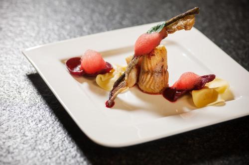 a plate of food with fruit on it at Naturhotel Bauernhofer in Heilbrunn