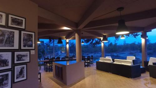 a living room with couches and a table and chairs at I love phants Lodge in Ban Huai Thawai