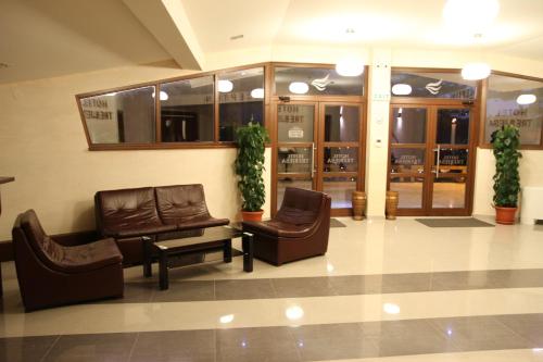 a lobby with couches and chairs in a building at Hotel Trebjesa in Nikšić