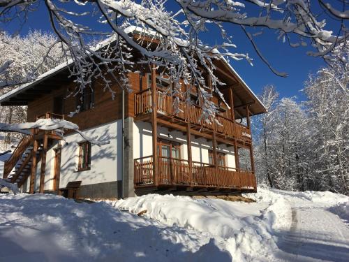 a log cabin in the snow with snow at Apartmány Planina Predná Hora in Predná Hora