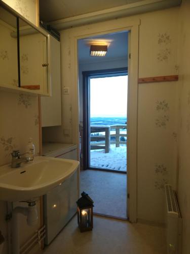 a bathroom with a sink and a view of the ocean at Fjällsikten Apartment in Granberget