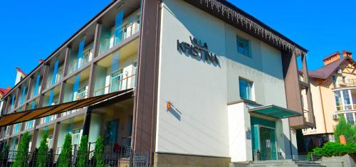 a building with a sign on the side of it at Villa Kristina in Truskavets