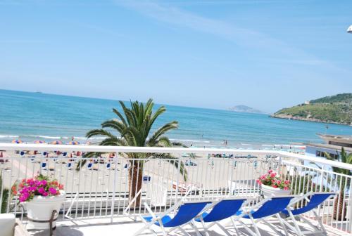 a view of a beach with chairs and the ocean at Hotel Villa Eleonora in Scauri