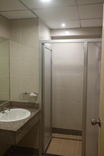 a bathroom with a sink and a shower at Floral Shire Suvarnabhumi Airport in Lat Krabang