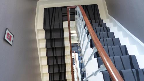 a stairway with blue and white stairs in a building at Hotel De L'Europe in Toul