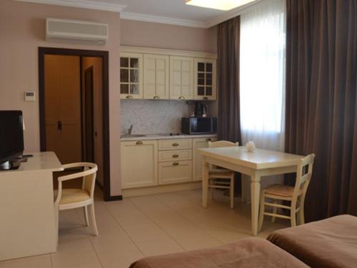 a kitchen and dining room with a table and chairs at Villa Kristina in Truskavets
