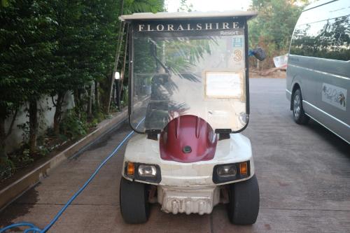 a golf cart parked on the side of a street at Floral Shire Suvarnabhumi Airport in Lat Krabang