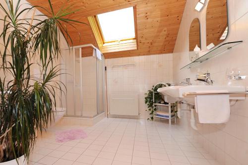 a bathroom with two sinks and a shower at Appartment Gertrud Flatz in Sankt Anton im Montafon