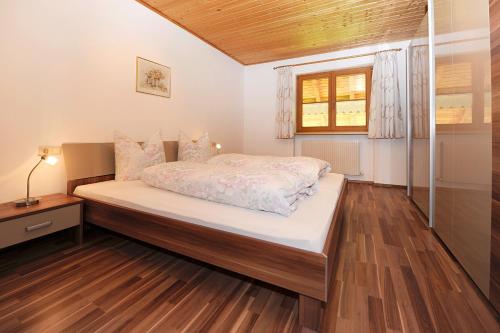 a bedroom with a bed and a window at Appartment Gertrud Flatz in Sankt Anton im Montafon