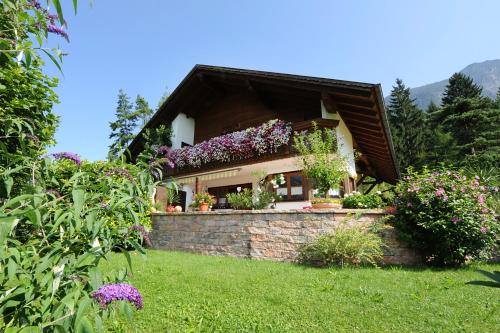 a house with flowers on the side of it at Appartment Gertrud Flatz in Sankt Anton im Montafon