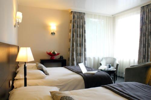 Katil atau katil-katil dalam bilik di Le Manoir Hôtel
