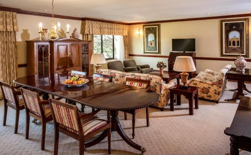 a living room with a table and a couch at Avani Gaborone Resort & Casino in Gaborone