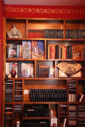 a wooden book shelf filled with lots of books at Almunia de San Miguel in Toledo