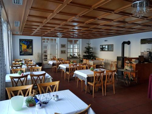 a dining room with white tables and chairs at Gut Lauterbad Hotel in Freudenstadt