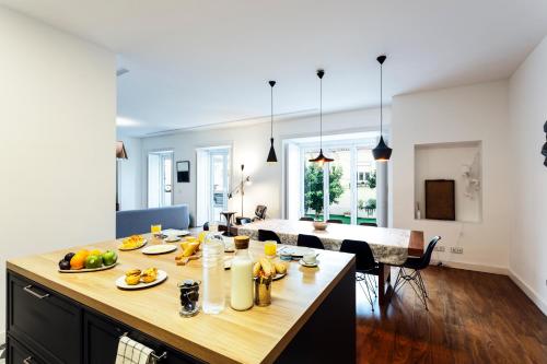 a kitchen and living room with a table with fruit on it at Chalet Estoril Luxury Apartments in Estoril