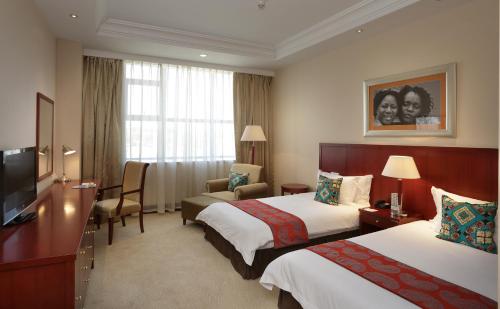 Ένα ή περισσότερα κρεβάτια σε δωμάτιο στο President Hotel at Umodzi Park